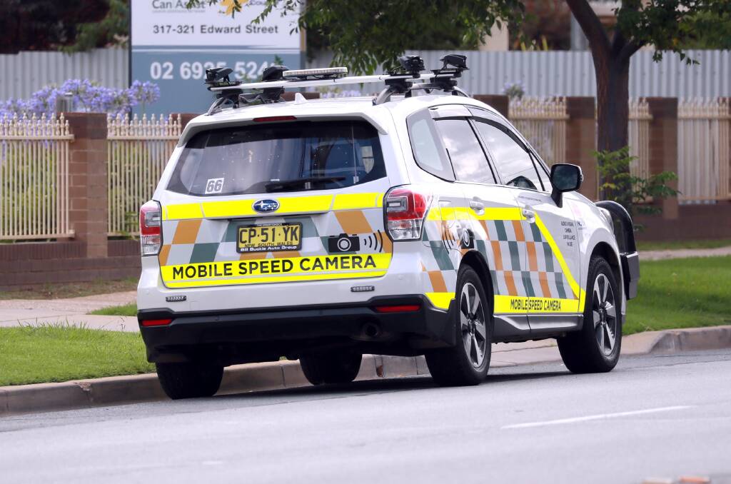 CHANGES: A mobile speed camera vehicle parked on the side of a suburban road. The 45 vehicles deployed statewide will soon have their high-visibility decals either reduced or removed. Photo: LES SMITH