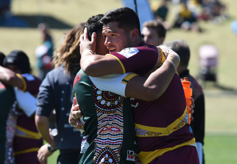 HOW FAR WE'VE COME: Coonamble juniors turned NRL stars Jesse Ramien (left) and Braidon Burns (right) embrace after their sides clashed on Sunday. Photo: AMY MCINTYRE