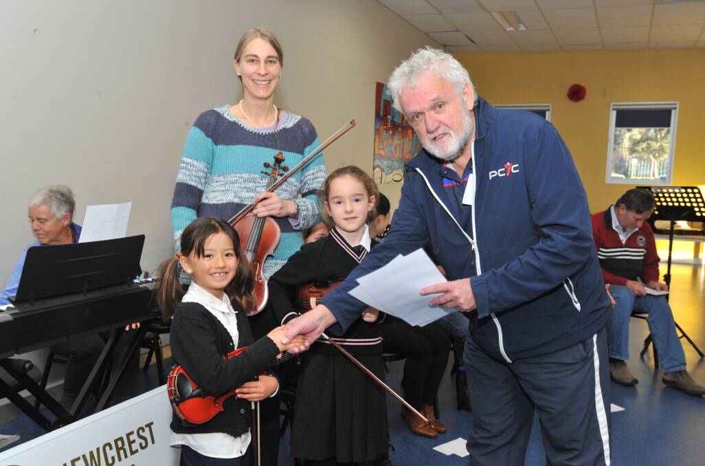 Vital Volunteers: Violin teacher and volunteer Birgit Loecker with assistant manager Dave Cleal presenting Orange PCYC scholarship winners Ayla Daskein and Lucy Goodacre with their awards. Photo: Jude Keogh.