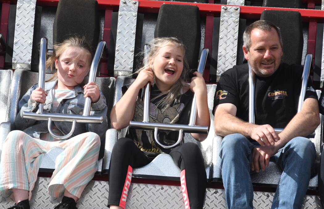 WHAT A RIDE: Attendees Emily Swain, Zalia and Damian Culverson go for a spin at the weekend's 149th Orange Show. PHOTO: JUDE KEOGH 
