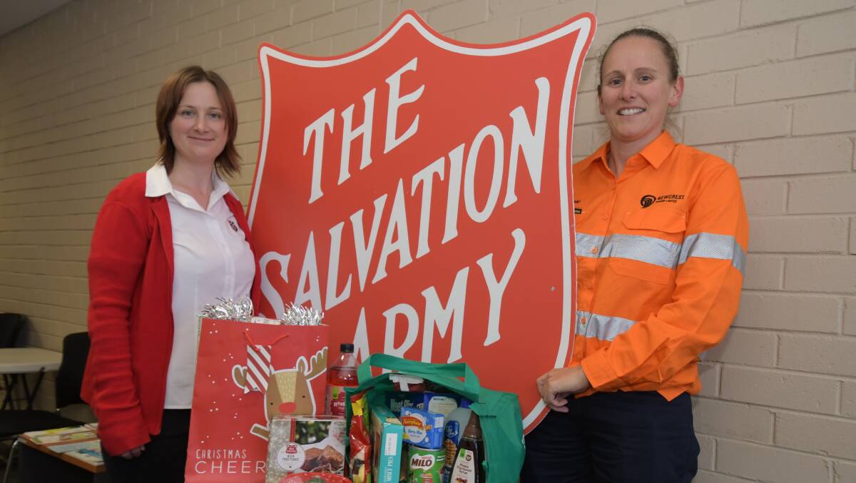 SHOP FOR ORANGE: Salvo's Kate Cathcart with Newcrest Mining's Nicole Morris with one of the Christmas hampers that are being given to local families doing it tough. PHOTO: JUDE KEOGH 