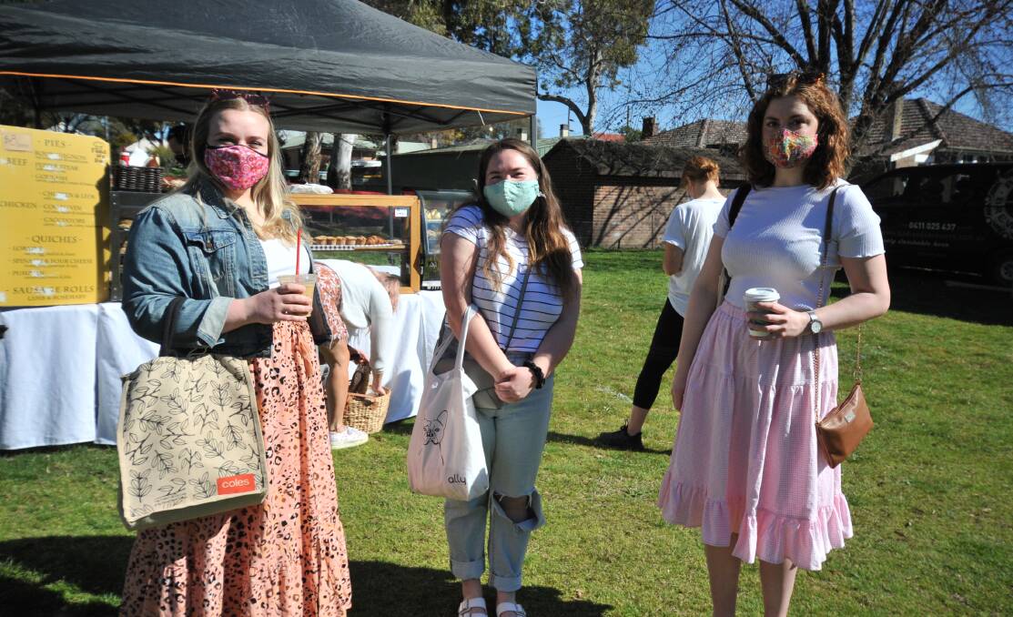 LOVELY DAY FOR IT: Shoppers at last month's markets: Emily Sutherland, Jade Reid and Mollie Gorman. PHOTO: JUDE KEOGH