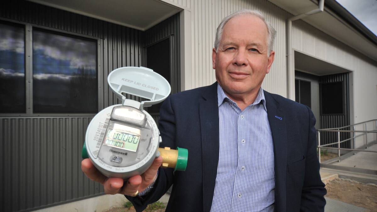 WATER SAVING: Orange City Council Infrastructure policy committee chair Jeff Whitton with one of the new smart water metres. PHOTO: JUDE KEOGH