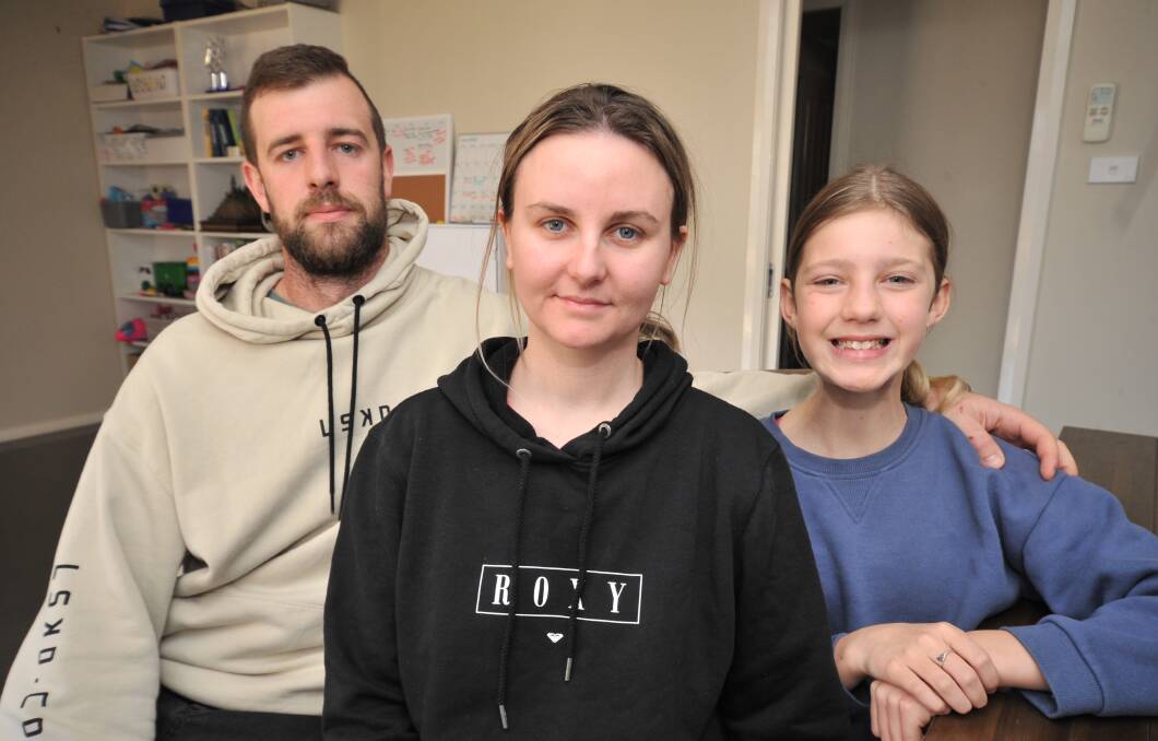 FIGHTER: Stacie Griffiths, 27, (centre) with her husband Luke and step-daughter Alira Griffiths. PHOTO: JUDE KEOGH