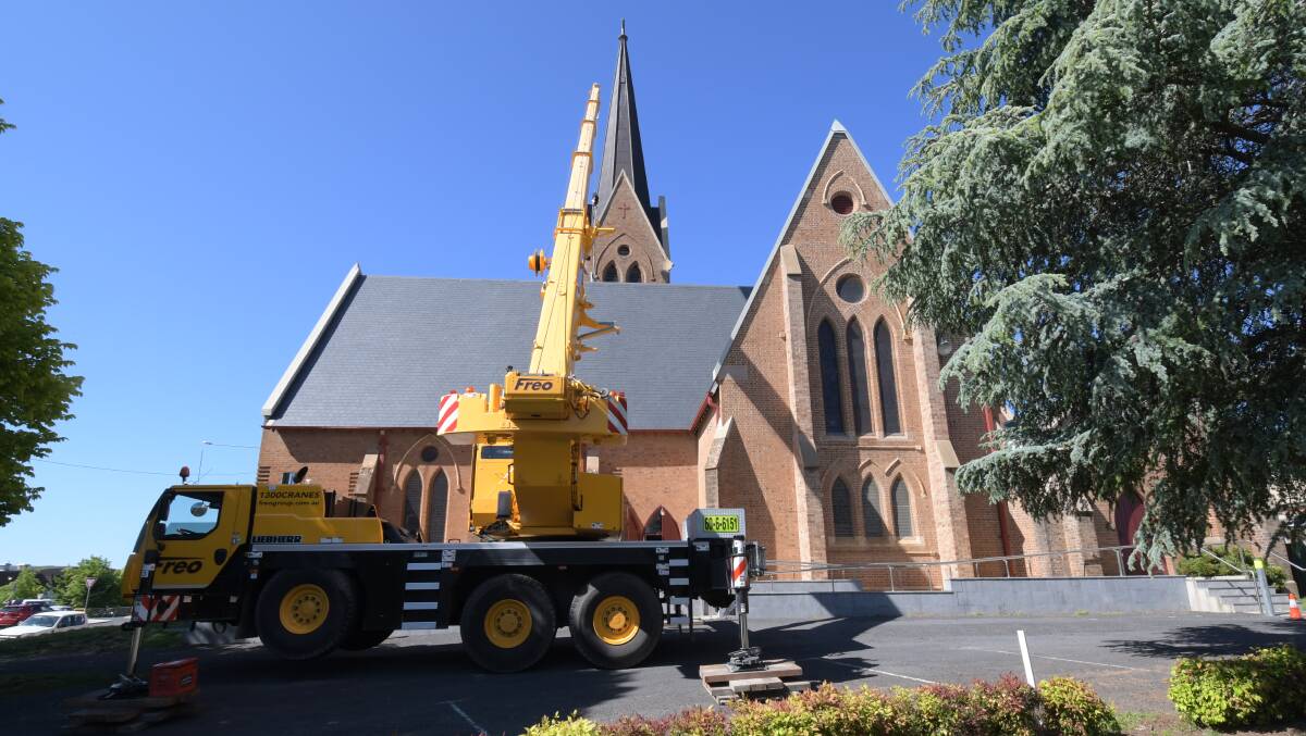 Freo Cranes used a crane, a drone and four workmen to put the bell into the Holy Trinity Church on Tuesday morning. PHOTO: CARLA FREEDMAN
