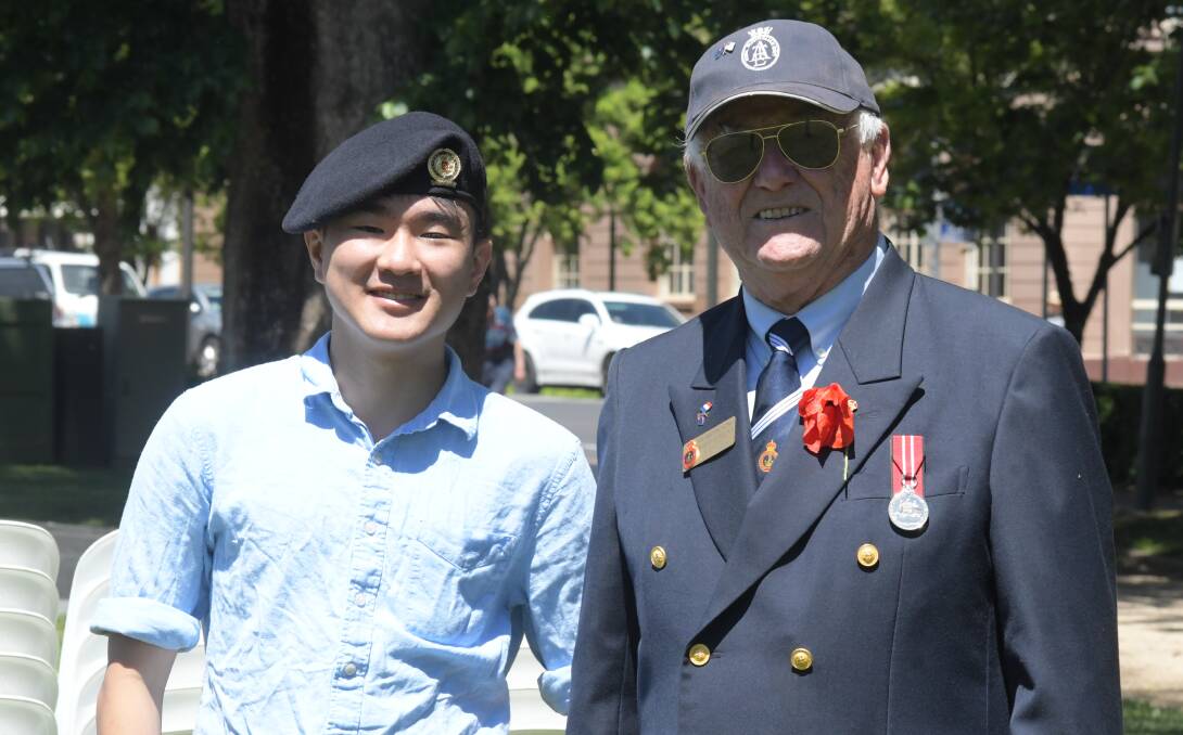 MATESHIP: International student Sam Chan and veteran Barry Collins had a lot to yarn about at Remembrance Day. PHOTO: JUDE KEOGH