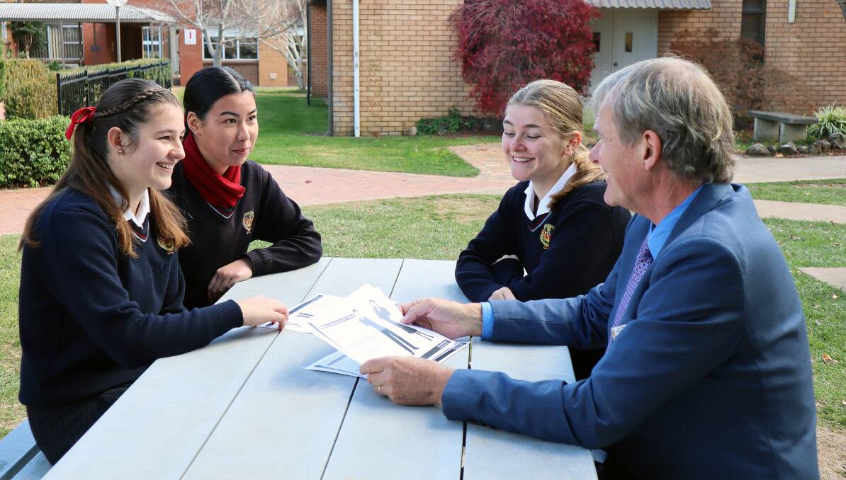 NEW SCHOOL UNIFORM RULE: James Sheahan Catholic High School principal Peter Meers with Year 12 student leaders; Elizabeth Gibson, Sarah Gee and Piper Want. PHOTO: SUPPLIED