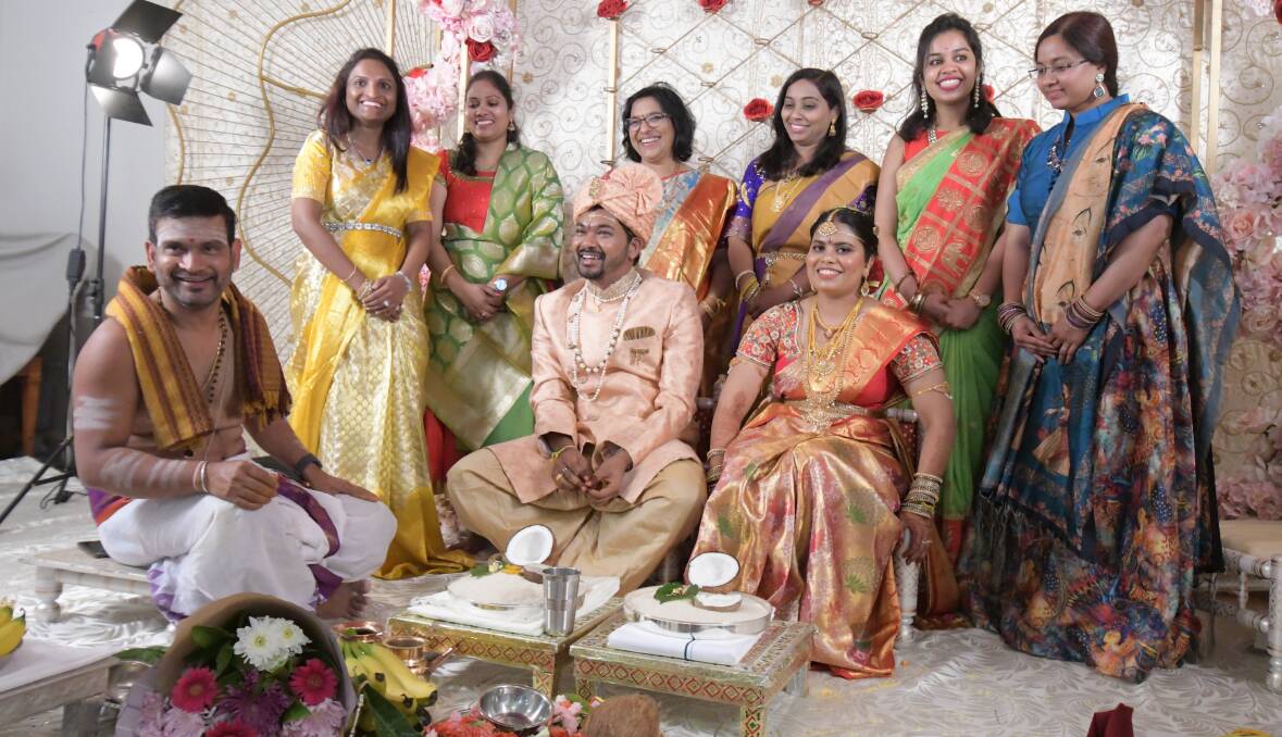 BIG DAY: Achar (priest), Prasanna Rongali, Usha Sunke, (mother-of-the-bride) Anantha Maddirala, Sowjanya Yenugapalli, Krishna Teja (groom), Sri Ramya (bride), Sai Shruthi and Divya Kattn. PHOTO: JUDE KEOGH