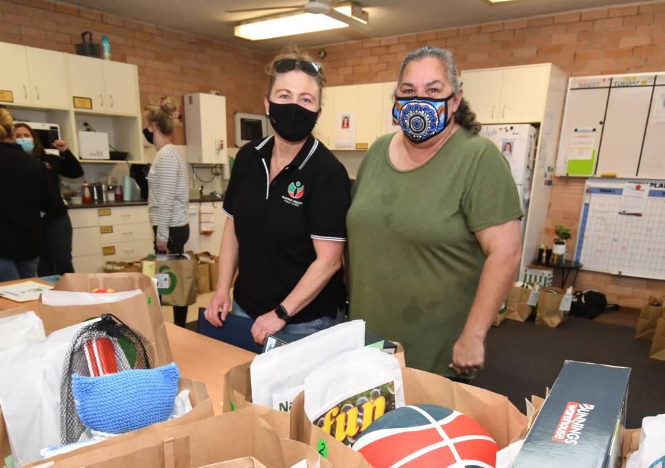 Kylie Watts and Sharon Horton preparing the packs for primary school kids on Thursday. 