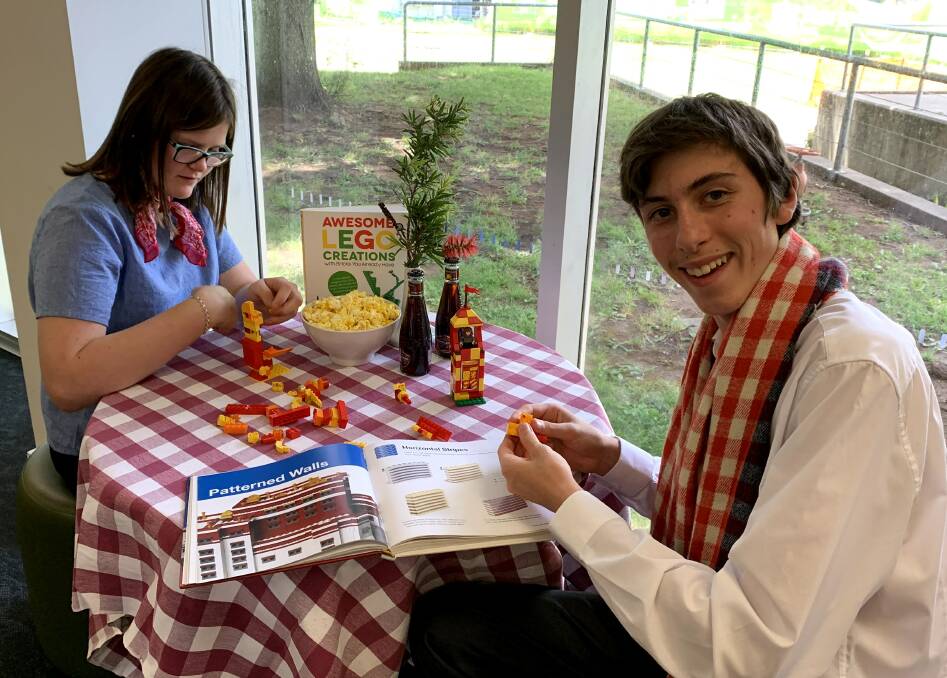 BOOK LOVERS: Library trainees Claire Quinn and Andreas Kuegler have been preparing picnics and Lego sets for Library Lovers' Day on Sunday, February 14. PHOTO: SUPPLIED 