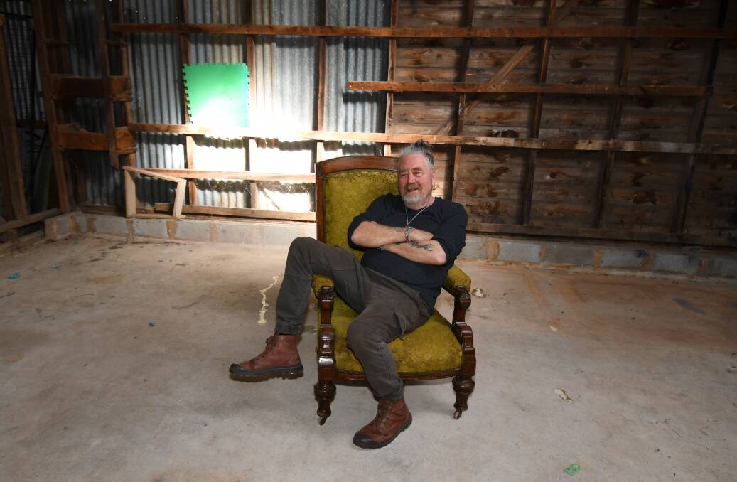 SOLD OUT: Steve Archer sits in the middle of the empty shed which he managed to clear of the Colonial-era antiques and art in the one day. PHOTO: CARLA FREEDMAN