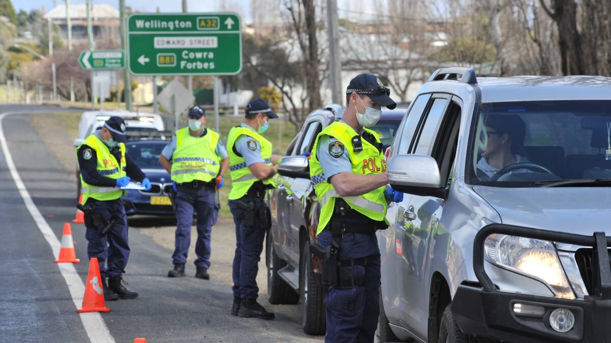 OPERATION STAY AT HOME: Police performing road-side breath and licence checks in Molong on Tuesday morning. PHOTO JUDE KEOGH