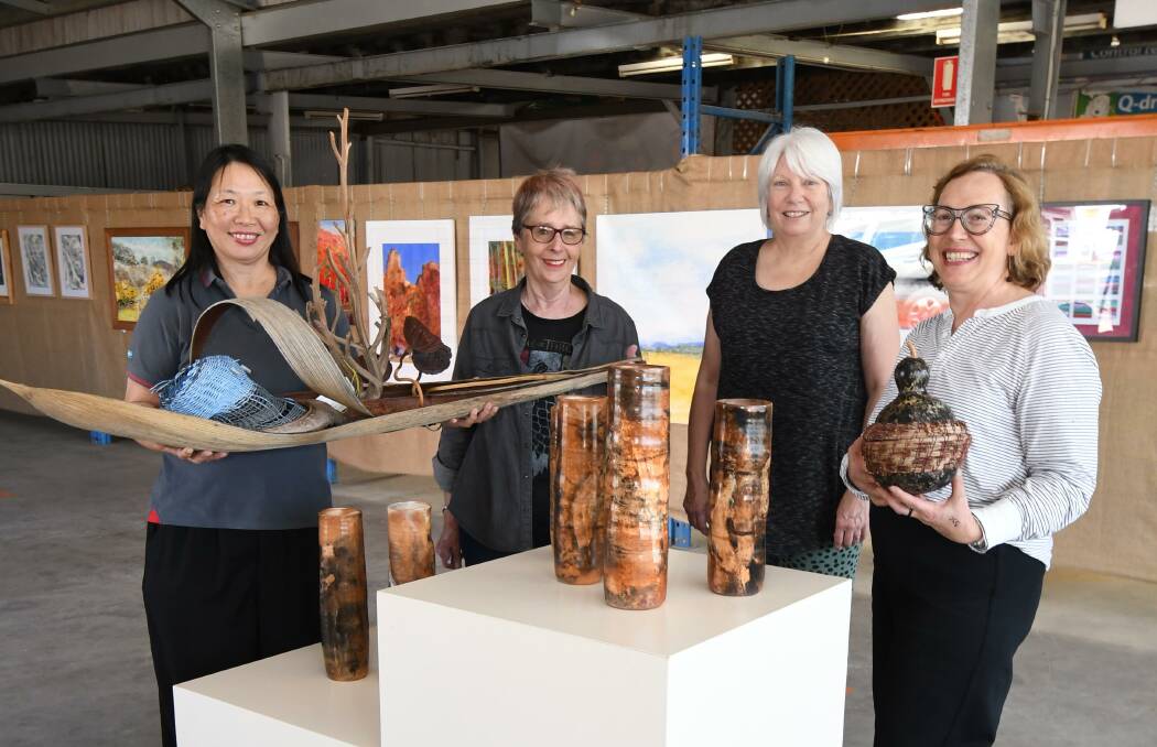 EARTH WORK: Colour City Creative artists Lanny Mackenzie, Margot Huebner, Judy Kich and "media mama" Jolanta Nejman with some of the art available for purchase at this weekend's exhibition. PHOTO: JUDE KEOGH