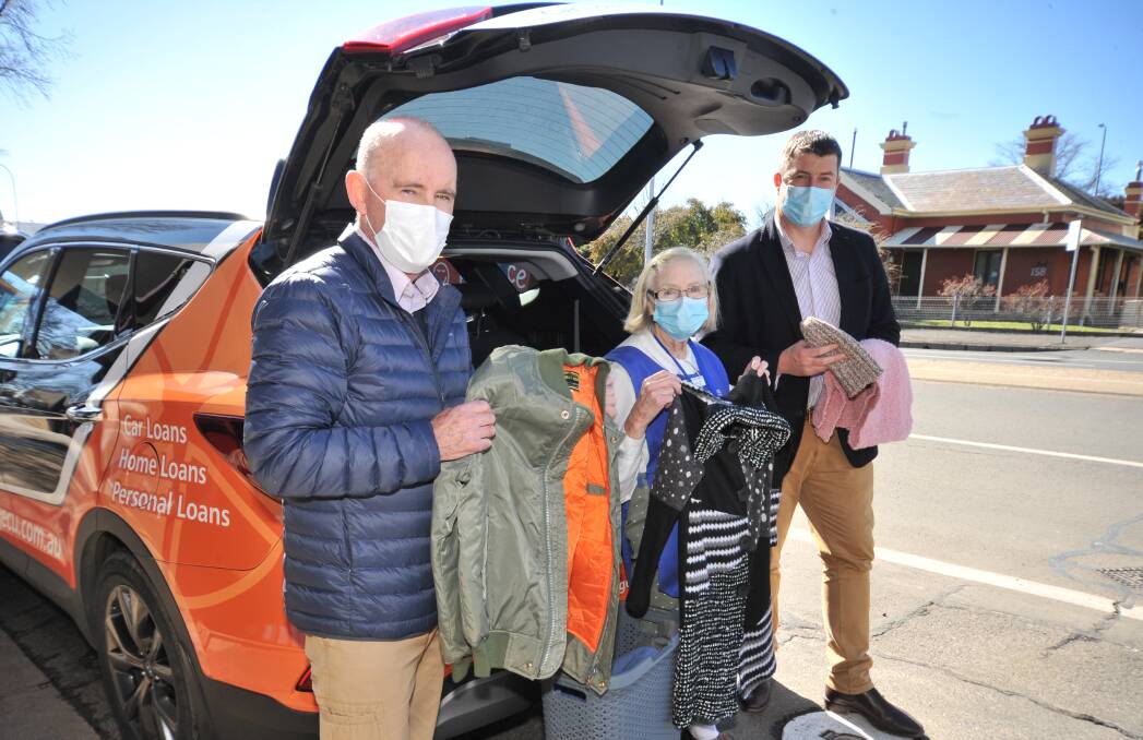 WINTER WARMERS: Bill Kelly and Patricia Mannix with Orange Credit Union CEO Andrew De Graaff. PHOTO: JUDE KEOGH