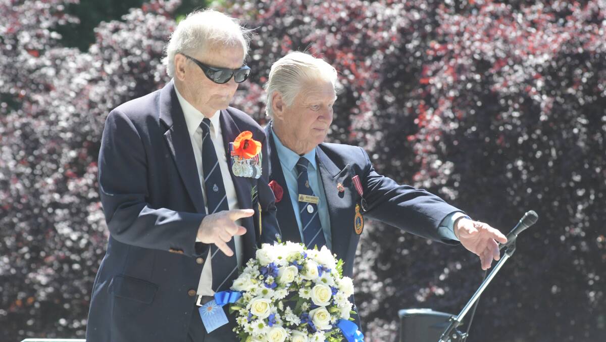 Graeme Harris and Ken Harper from the Naval Association lay a wreath at Robertson Park's war memorial. 
