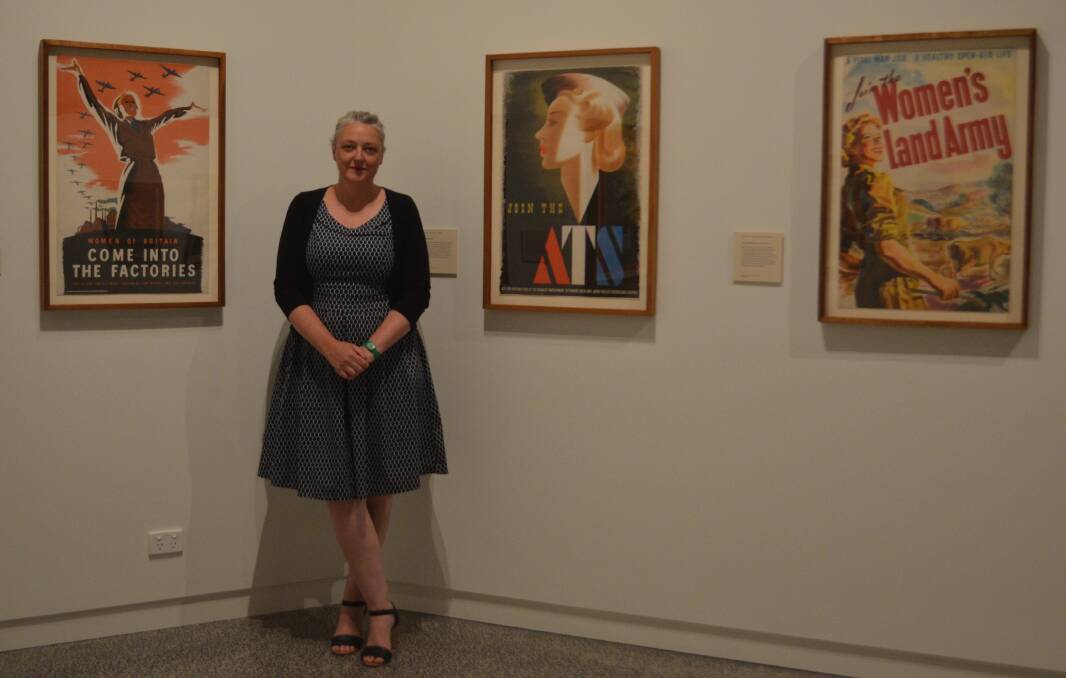 WORLD OF THE PAST: Museum manager Mary-Liz Andrews with the posters from World War II depicting women's role in the war effort. PHOTO: ALANA CALVERT