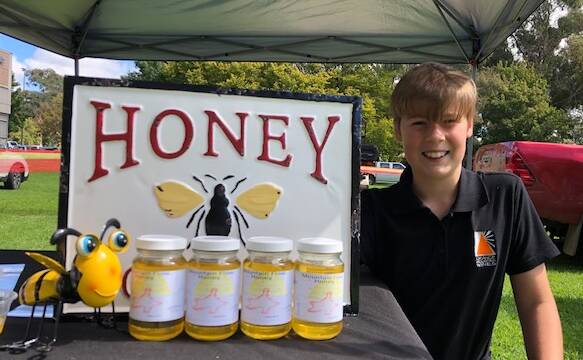 BUSINESSMAN: Josh Dolle, 13, with the honey he produces from his own hives. PHOTO: ALANA CALVERT