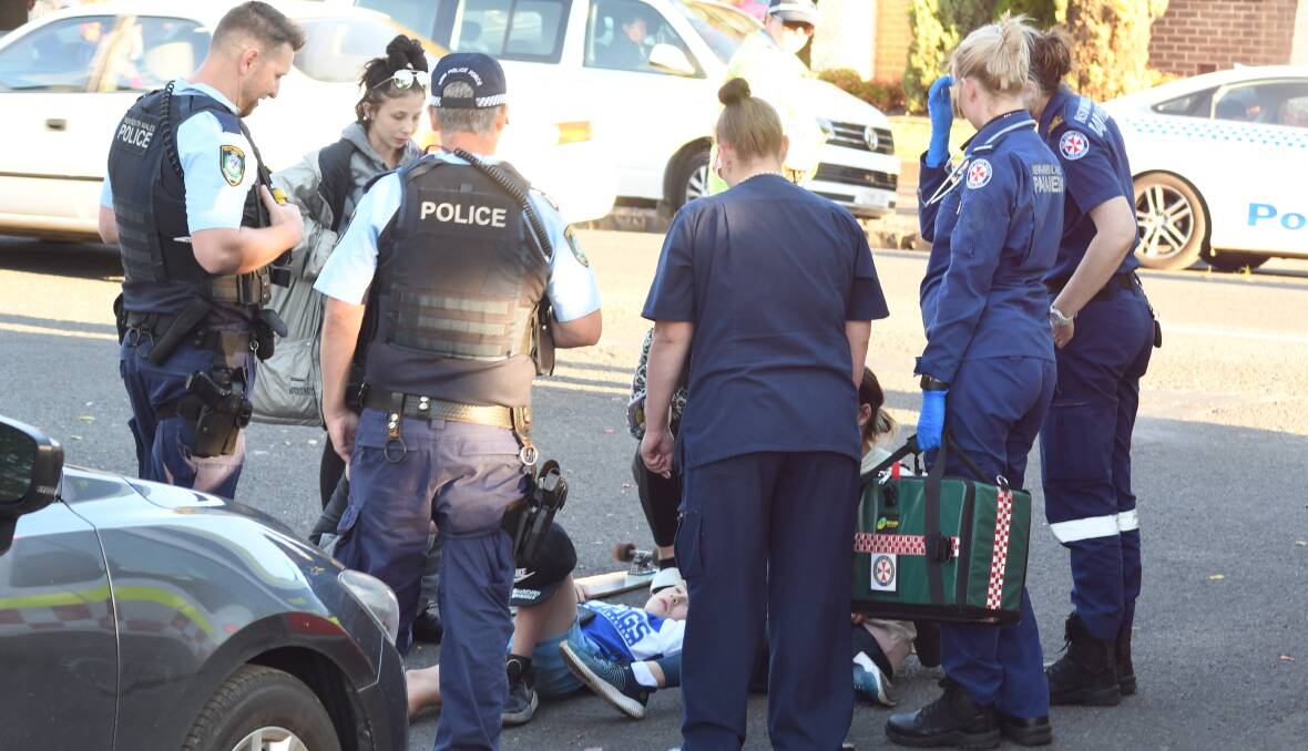 Police and paramedics attend to the young boy at the scene. PHOTO: JUDE KEOGH