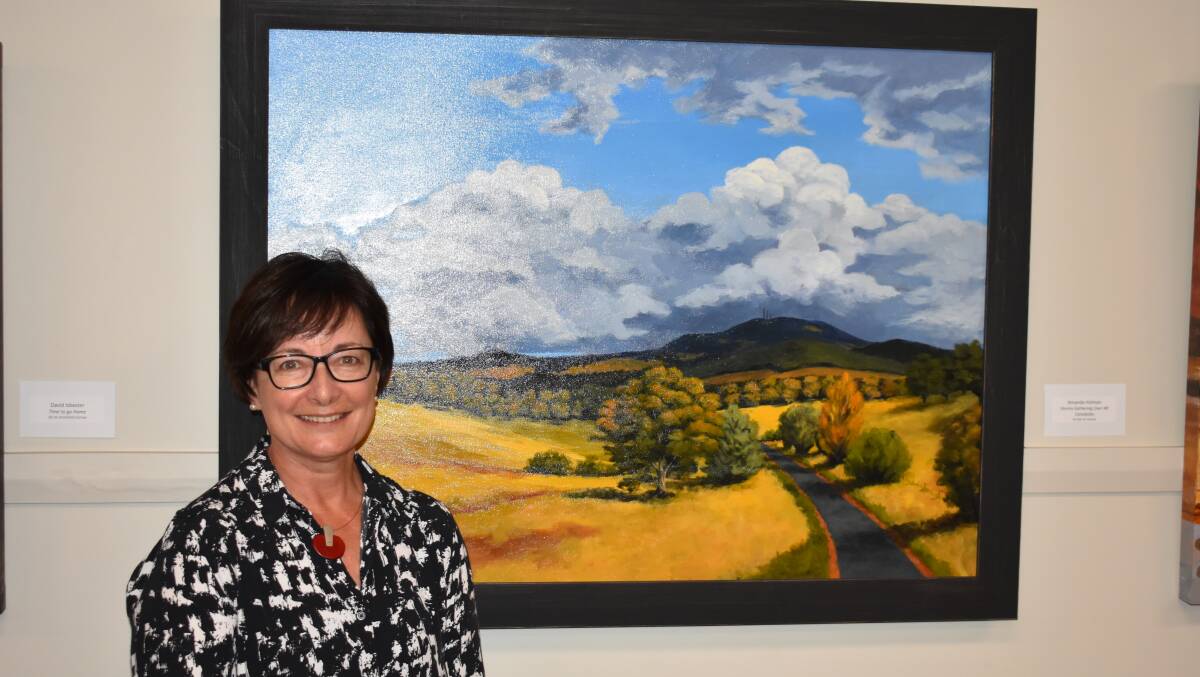 OPEN TO CREATIVES: Amanda Holman with her 2021 Cabonne Acquisitive Art Prize winning work, 'Storms Gathering Over Mount Canobolas'. PHOTO: SUPPLIED
