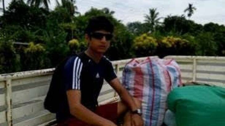 Refugee Loghman Sawari, 20, pictured in Lae with all his possessions, wants to return to the relative safety of the Manus transit centre. Photo: Supplied