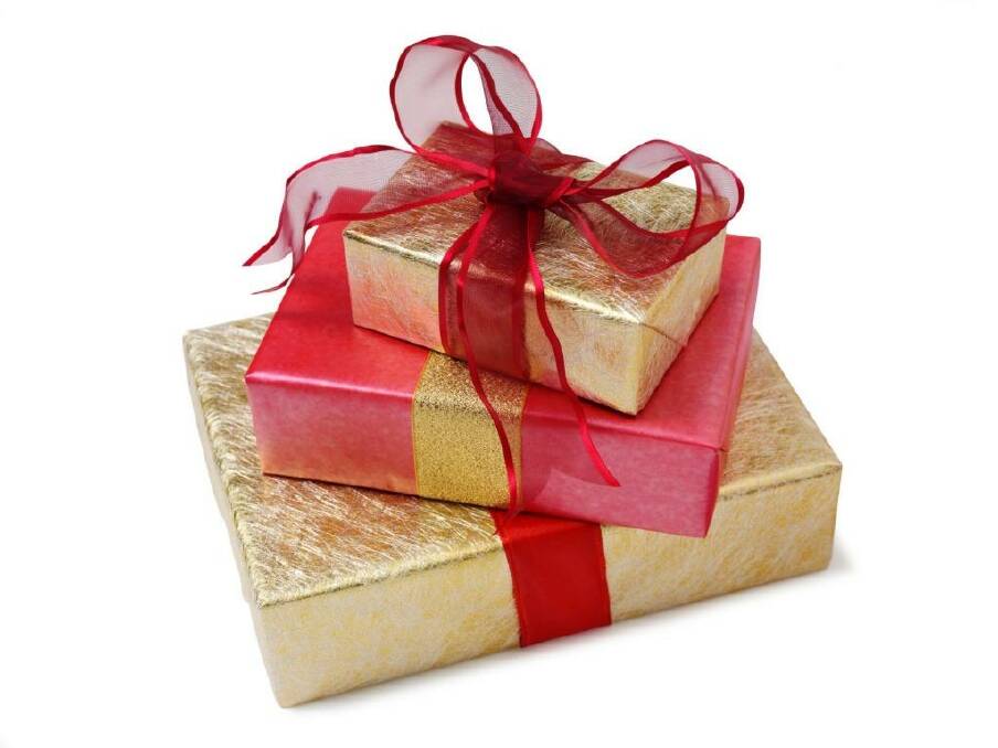 A stack of presents wrapped in gold paper with a red bow. Picture is from file
