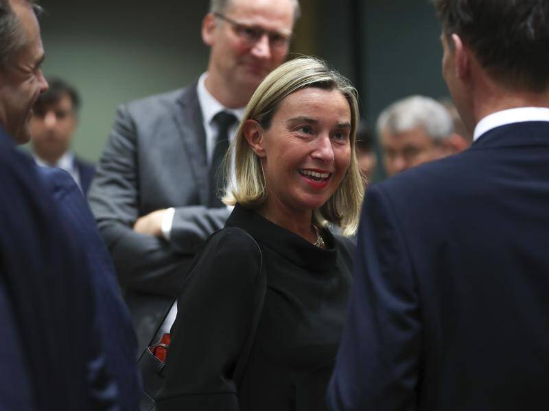EU foreign policy chief Federica Mogherini (C) says the steps taken by Iran are reversible.