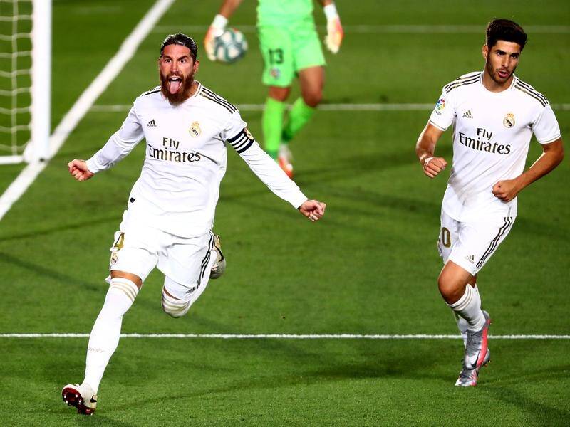 Real Madrid's Sergio Ramos (l) celebrates scoring his fourth goal in six matches to see off Getafe.