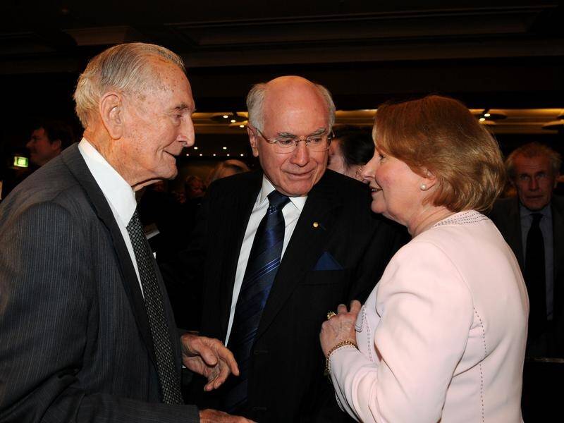 Former Prime Minister John Howard has paid tribute to Sir John Carrick (L) who has died aged 99.