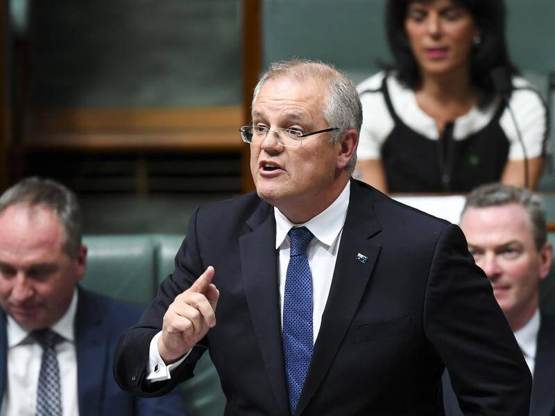 Treasurer Scott Morrison says corporate tax cut delays are slowing wage rises for workers (File).