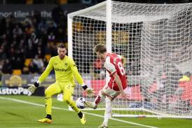 Martin Odegaard scores Arsenal's second goal in a crucial 2-0 win over Wolves. (AP PHOTO)