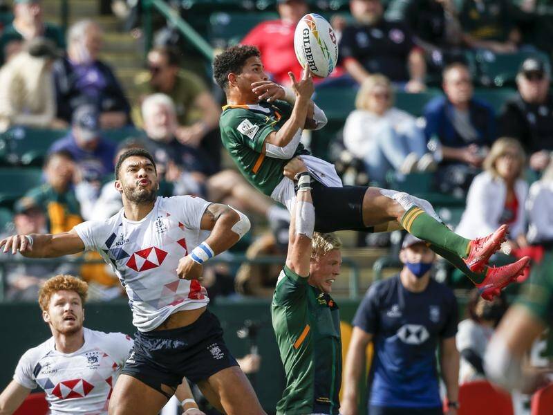 South Africa's Ronald Brown receives a helping hand in their rugby sevens campaign in Edmonton