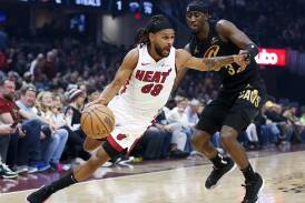 Miami Heat guard Patty Mills drives against Cleveland's Caris LeVert in the three-point win. (AP PHOTO)
