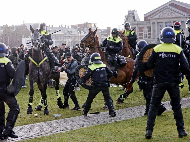 Riot police used horses and a water cannon to disperse protesters in Amsterdam.