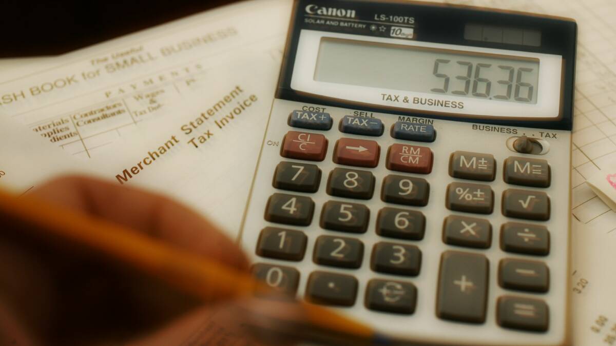 Generic photo of a calculator and some business papers. Picture is from file