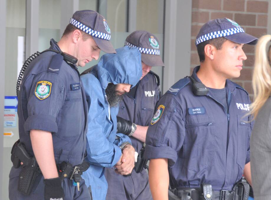 BEATEN: Malcolm Naden, pictured being escorted by police in March 2012 after seven years on the run, was attacked at the Goulburn Correctional Facility by his cousin Dean Nolan over the murder of Lateesha Nolan. 											          			       Photo: FILE