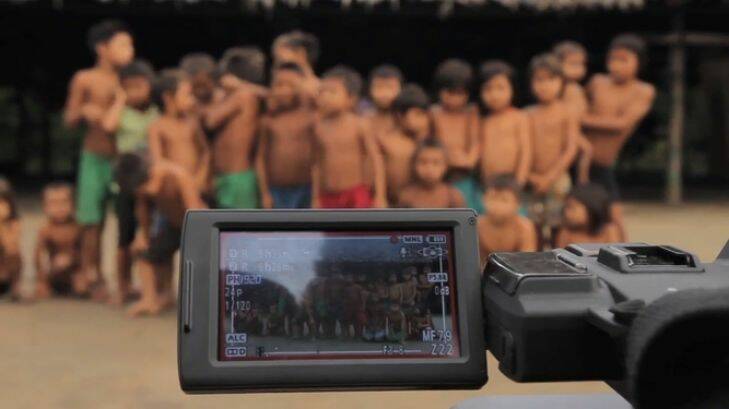Romeu Iximaw????teri Yanomami (behind the camera) and?? Silvano Ironasiteri Yanomami to his right, organise Yanomami children for a video shoot.