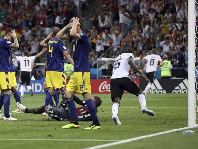 Sweden players can't believe they have been beaten by Toni Kroos's goal for Germany.