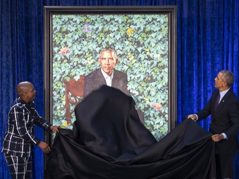 Former US President Barack Obama and wife Michelle have helped unveil their official portraits.