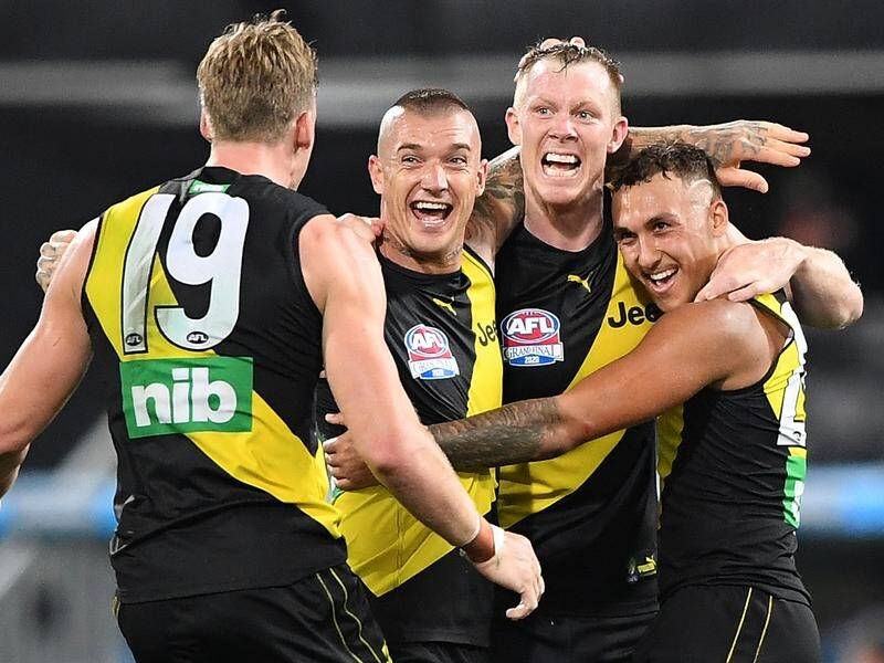 Tiger Dustin Martin (2-l) was voted the AFL grand final's best on ground for a record third time.