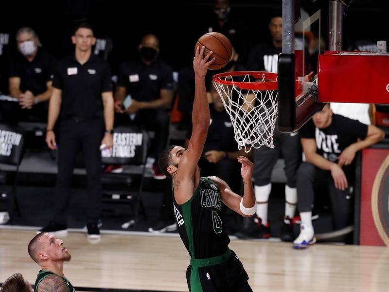 Boston's Jayson Tatum turned on the power as the Celtics kept the Miami Heat at bay in the NBA.