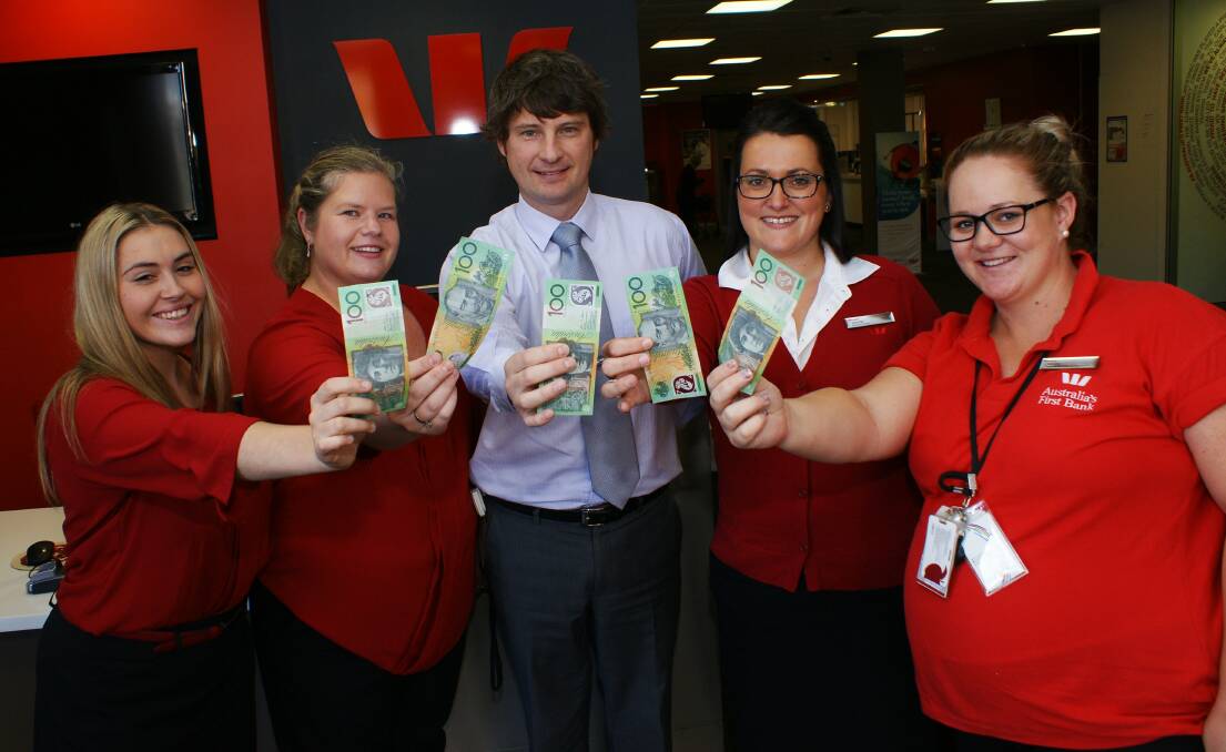 A DECENT DEPOSIT: Westpac Orange branch staff members Yvana Pazin, Amy Campbell, Katrina Barrett and Tammy Johnson will be helping bank manager Matt Eades (centre) choose a charity or not-for-profit organisation to donate $500 to.  
Photo: MARK LOGAN 0504mlwestpac1
