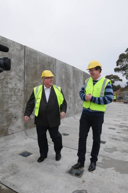 Member for Orange Andrew Gee and Orange mayor John Davis inspect the raised dam wall.