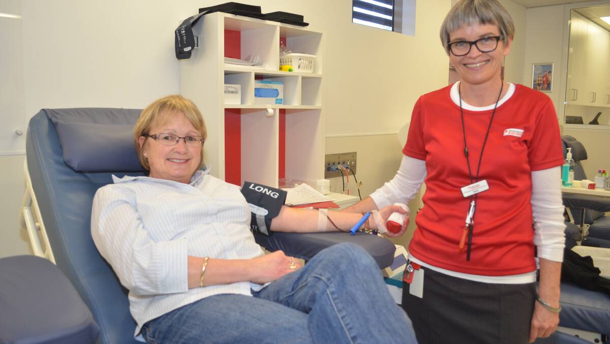 HAPPY TO HELP: Orange Red Cross Blood Service nurse Therese Goodacre tends to Debra Crump, who was happy to roll up her sleeve to help answer the blood service’s call for more donations. Photo: LUKE SCHUYLER              0818lsblood3
