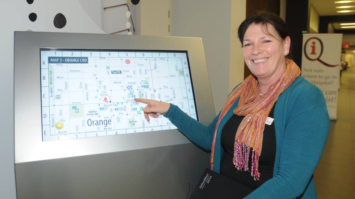 SIGN OF THE TIMES: Orange hospital acting deputy director of nursing Cate Cleal tries out the new system which was installed in the foyer of the hospital yesterday. Photo: LUKE SCHUYLER 0630hospital 2