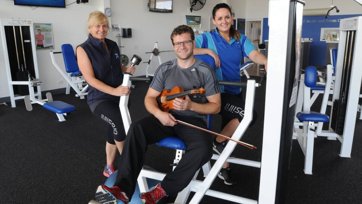 IN TRAINING: Integra Health Fitness and Wellbeing  super trainer Emma Quirk-Baker, violinist, personal trainer and group fitness instructor Andrew Baker and personal trainer and group fitness manager Claire McMillan are keen to hear the Mitchell Quartet perform mid workout. Photo: STEVE GOSCH 						        		                 0229sgintegra