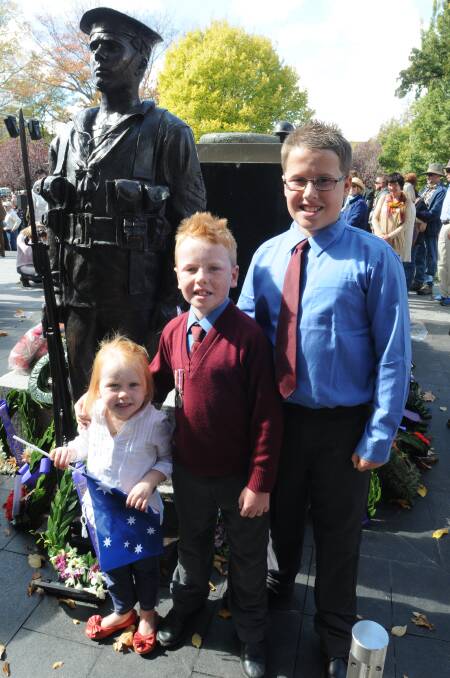 TRIBUTE: Pippi, Oliver and Thomas Jarick in front of the revamped cenotaph at Robertson Park. Photo: JUDE KEOGH 0425anzac79