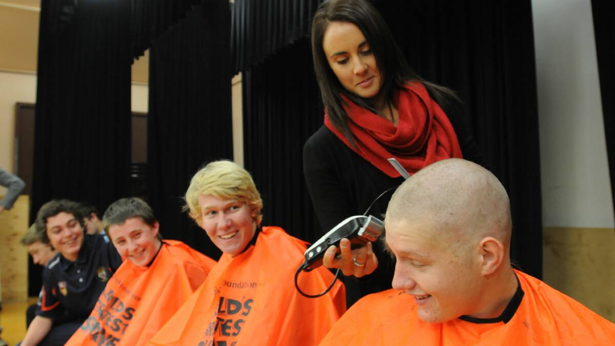 HERE WE GO: Nathan Neuenhaus (right) from Canobolas Rural Technology High School says he was inspired to raise funds to find a cure for Leukaemia after his grandfather managed to beat the disease. Lining up to join him in shaving their heads by Emily Bennett were Aiden Kelly, Tyson Wilkinson, Max Pearce, Cody Astill (obscured) and Jed Reid (obscured). Photo: STEVE GOSCH 0623shave1
