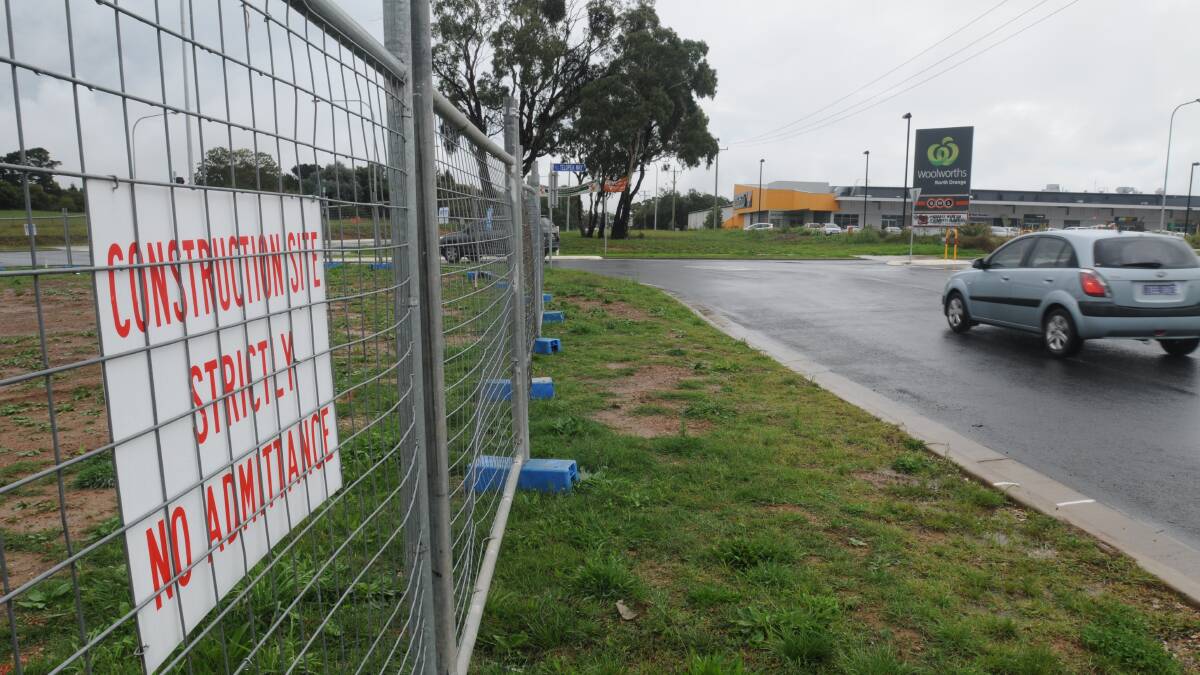 IT BEGINS: Construction fencing and site offices arrived at the McDonald’s Farrell Road site this week and work will begin on the intersection later this month. Photo: STEVE GOSCH  0328sgmaccas1
