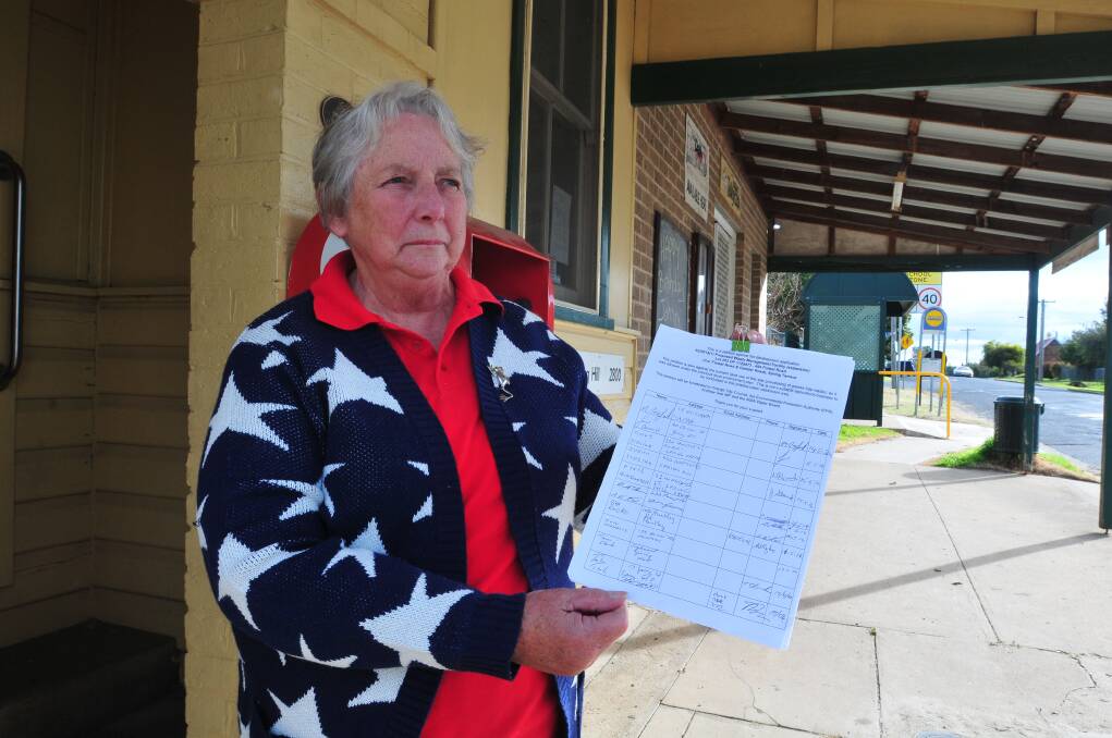 SAYING NO: Spring Hill postmistress Jan Davies with the petition against Polpure’s application to expand its waste facility at Spring Terrace. Photo: JUDE KEOGH                                                                                                                                                                                            0520springhill3