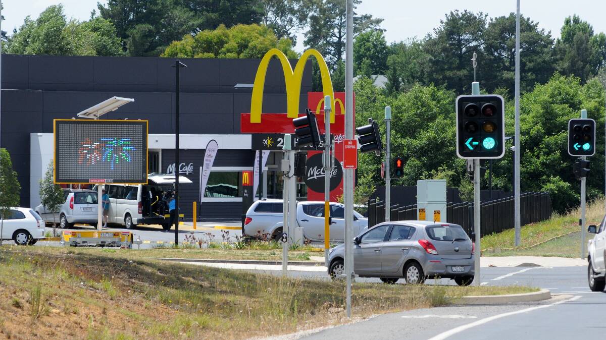 SIGN OF THE TIMES: Tony Roser says a portable sign near the traffic lights on the corner of the Northern Distributor Road and Telopea Way is dangerous. Photo: STEVE GOSCH 1201sgsign5
